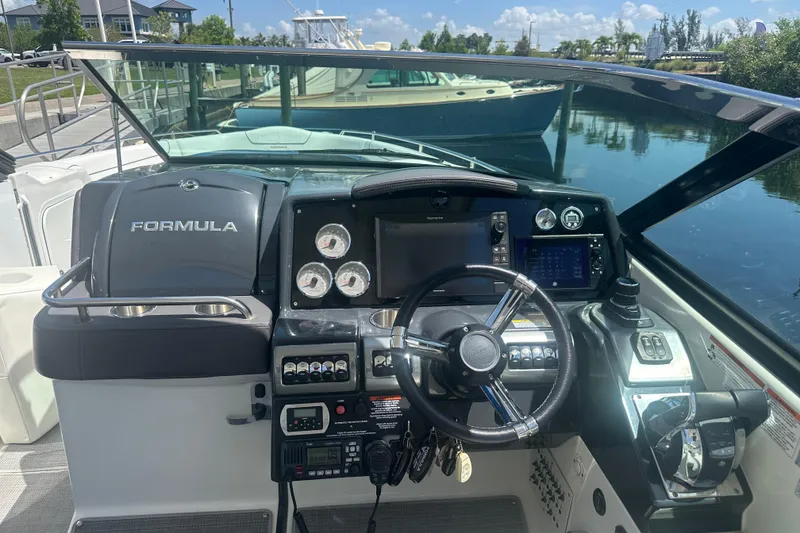 Slide: The Image of 2018 Formula 350 Crossover Bowrider OB dashboard with steering wheel and controls. - 23