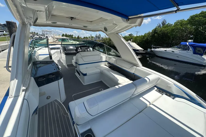 Slide: The Image of 2018 Formula 350 Crossover Bowrider OB with spacious seating and sleek design docked by the water. - 22
