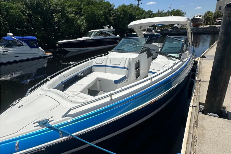 Slide: The Image of 2018 Formula 350 Crossover Bowrider OB docked, featuring sleek design and spacious seating. - 11