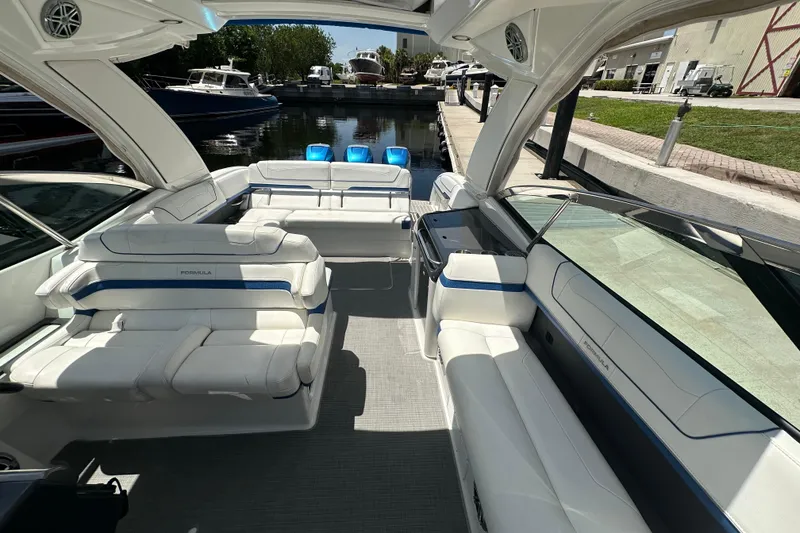 Slide: The Image of 2018 Formula 350 Crossover Bowrider OB with spacious seating and modern design at a marina. - 32