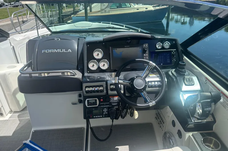 Slide: The Image of 2018 Formula 350 Crossover Bowrider OB dashboard with steering wheel and navigation controls. - 24