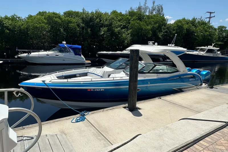 Slide: The Image of 2018 Formula 350 Crossover Bowrider OB docked, featuring sleek blue design and modern amenities. - 12