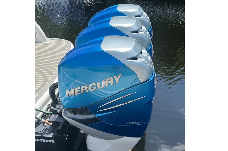 Slide: The Image of Three blue Mercury Verado outboard engines on a 2018 Formula 350 Crossover Bowrider OB. - 6