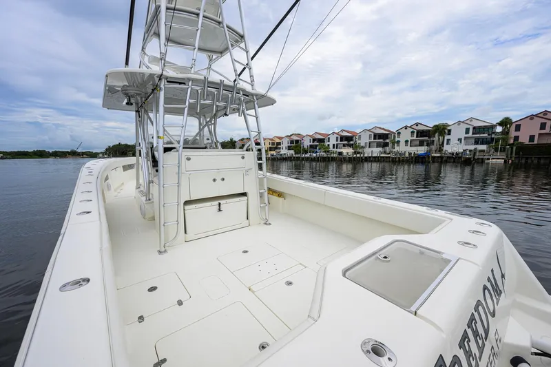 Slide: The Image of 2016 SeaVee 390Z boat with spacious deck, docked near waterfront homes. - 18