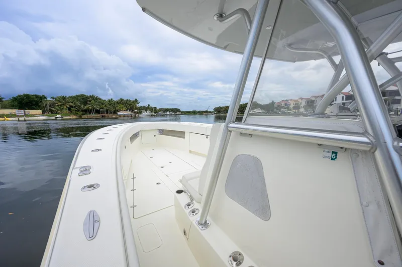 Slide: The Image of 2016 SeaVee 390Z boat docked by a scenic waterfront with palm trees. - 8