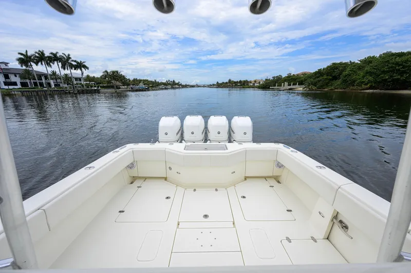 Slide: The Image of 2016 SeaVee 390Z boat with triple engines on a calm waterway. - 16