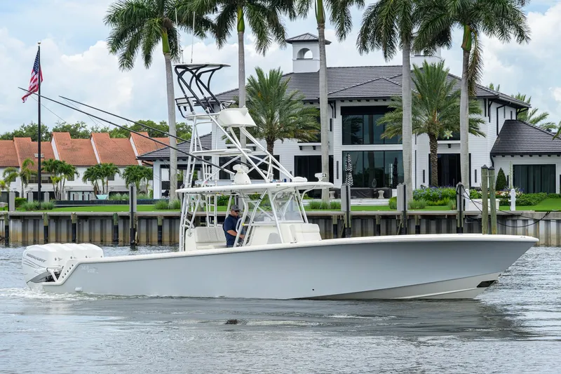 Slide: The Image of 2016 SeaVee 390Z boat cruising near waterfront mansion with palm trees. - 61