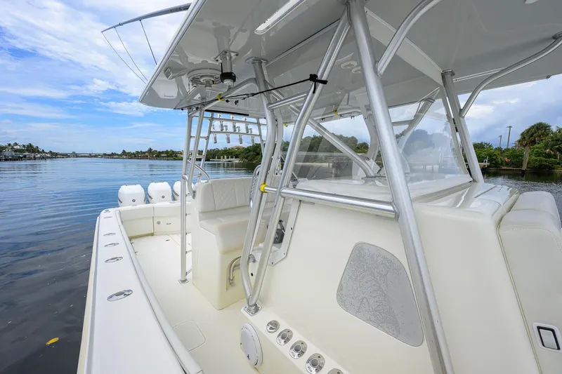 Slide: The Image of 2016 SeaVee 390Z boat interior with seating and rod holders on calm water. - 50