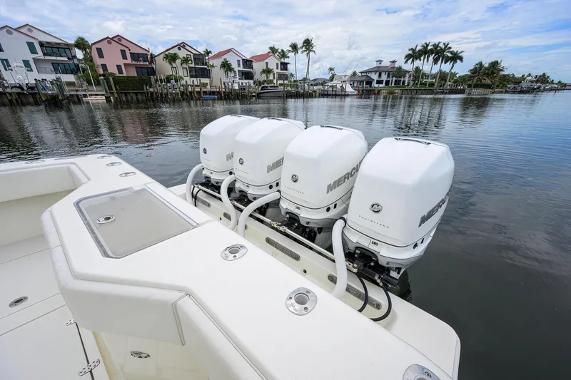 Slide: The Image of 2016 SeaVee 390Z boat with four Mercury outboard engines docked by waterfront homes. - 39
