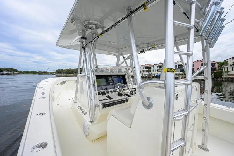 Slide: The Image of 2016 SeaVee 390Z boat interior with helm, ladder, and waterfront view. - 43