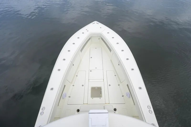 Slide: The Image of 2016 SeaVee 390Z boat bow view, showcasing spacious deck and sleek design on calm water. - 55