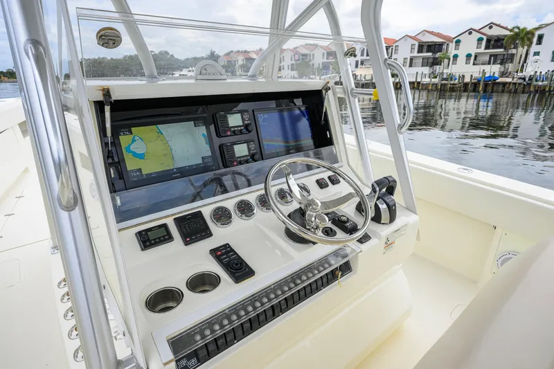 Slide: The Image of 2016 SeaVee 390Z boat dashboard with navigation screens and steering wheel. - 45
