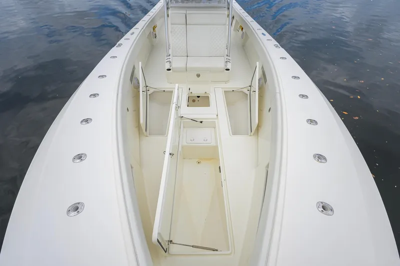 Slide: The Image of 2016 SeaVee 390Z boat deck with open storage compartments, surrounded by calm water. - 6
