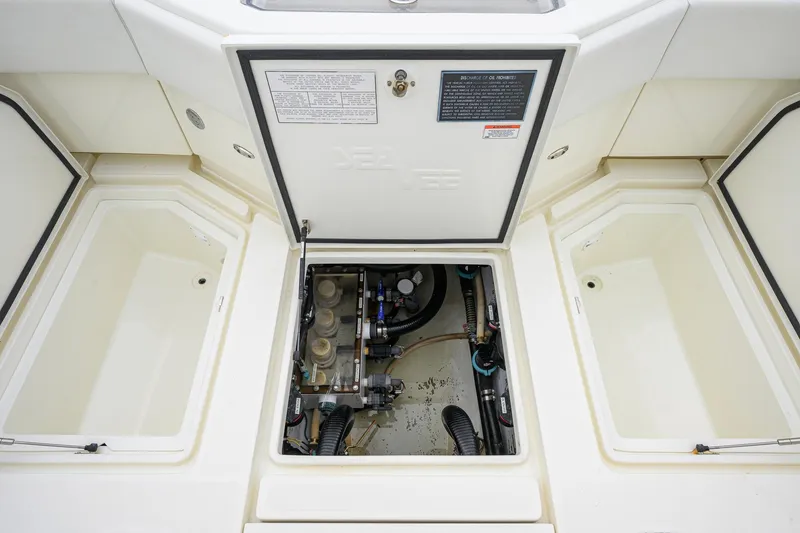 Slide: The Image of 2016 SeaVee 390Z boat storage compartments and access hatch, showcasing interior components. - 27