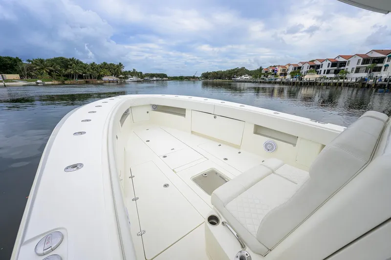 Slide: The Image of 2016 SeaVee 390Z boat with spacious deck, docked near waterfront homes. - 9