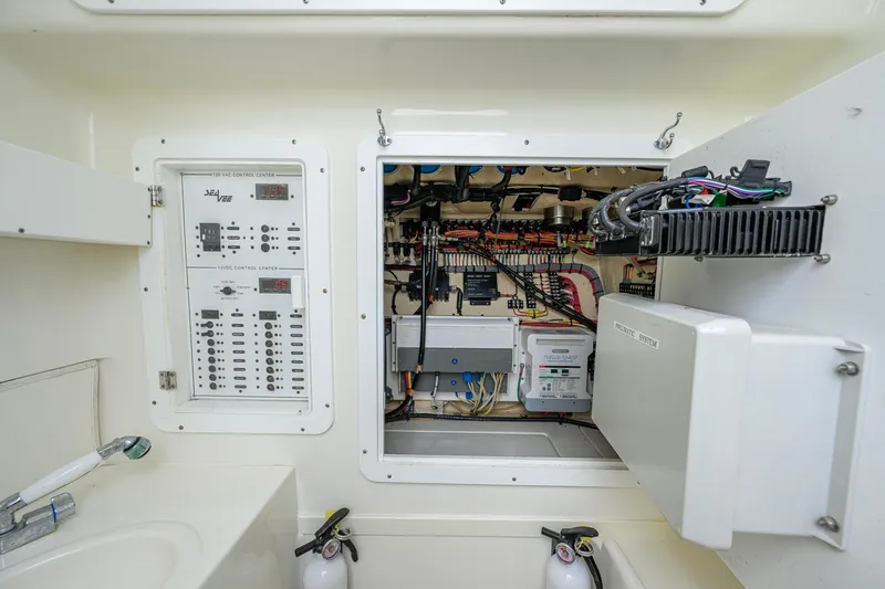 Slide: The Image of Electrical control panel of a 2016 SeaVee 390Z boat, showcasing wiring and systems. - 38