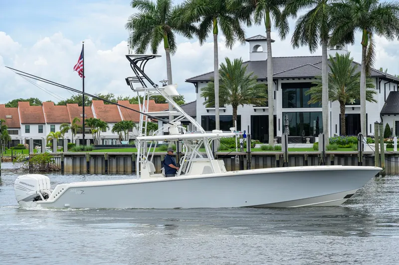 Slide: The Image of 2016 SeaVee 390Z boat cruising near waterfront homes with palm trees. - 60
