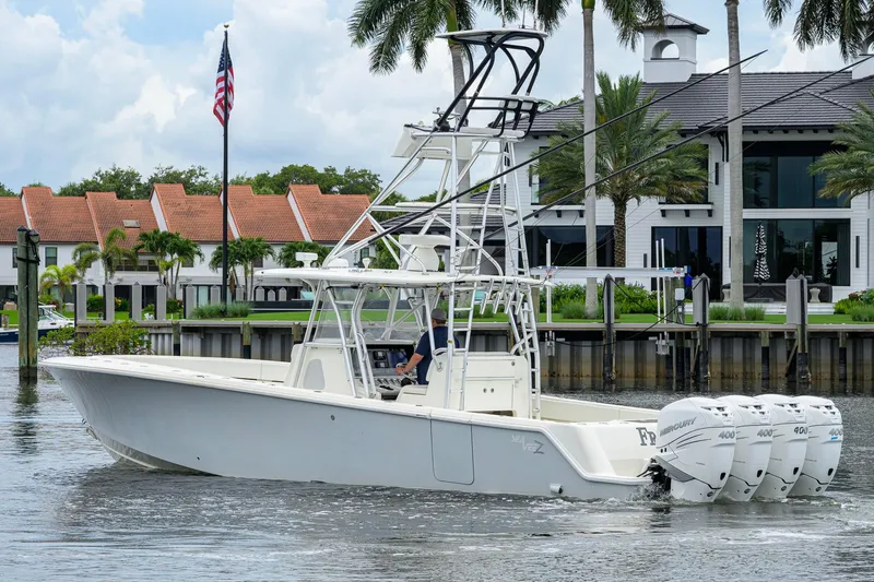 Slide: The Image of 2016 SeaVee 390Z boat with quad Mercury engines cruising near waterfront homes. - 66