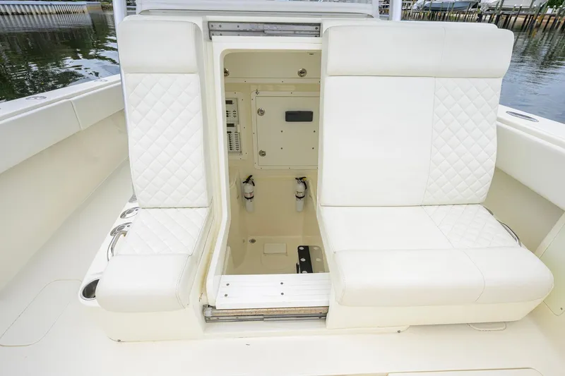 Slide: The Image of 2016 SeaVee 390Z boat interior with white quilted seating and storage compartment. - 33