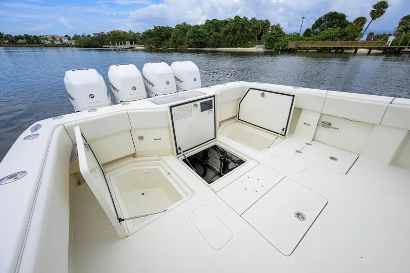 Slide: The Image of 2016 SeaVee 390Z boat with open storage compartments and four outboard engines. - 24