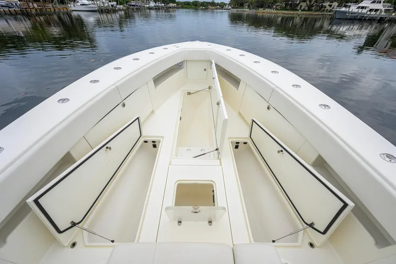Slide: The Image of 2016 SeaVee 390Z boat interior with open storage compartments on calm water. - 12