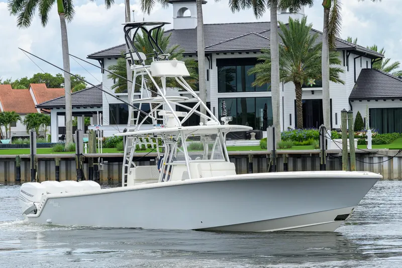 The Image of 2016 SeaVee 390Z boat cruising near luxury waterfront home with palm trees. - 0