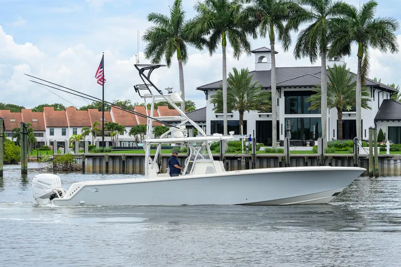Slide: The Image of 2016 SeaVee 390Z boat cruising near waterfront homes with palm trees. - 59