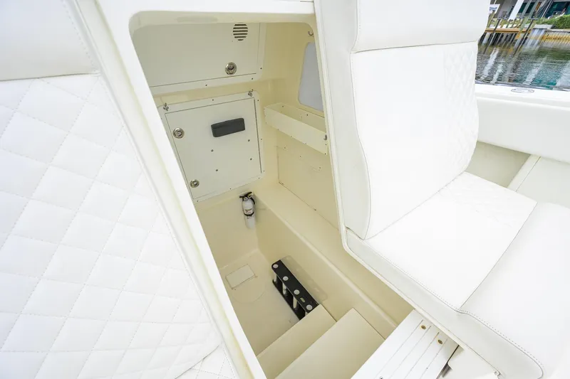Slide: The Image of 2016 SeaVee 390Z boat interior with white quilted seating and storage compartment. - 34