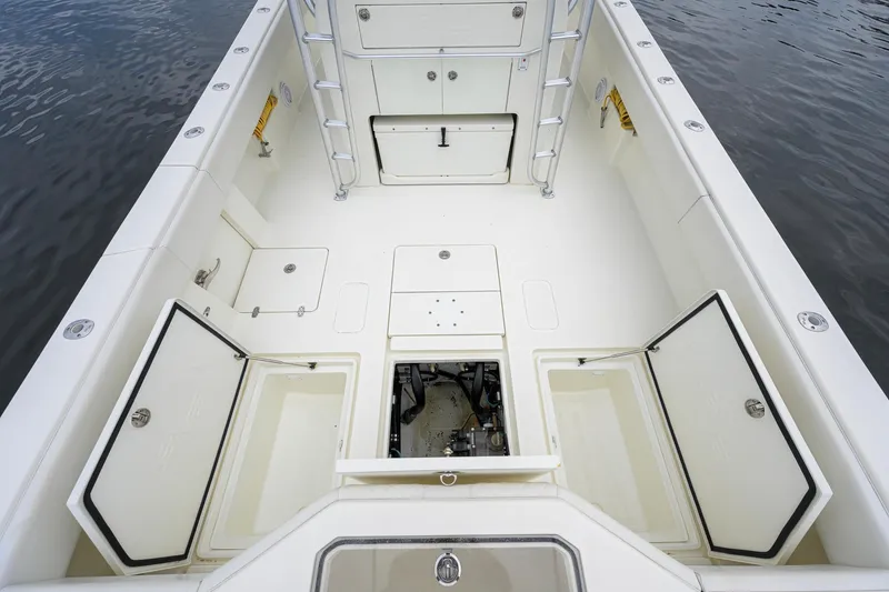 Slide: The Image of 2016 SeaVee 390Z boat deck with open storage compartments and ladder. - 23