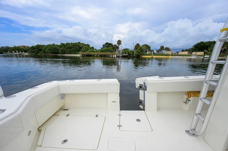 Slide: The Image of 2016 SeaVee 390Z boat deck overlooking calm waters and lush shoreline. - 31