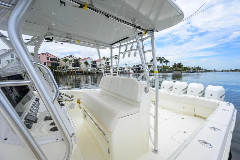 Slide: The Image of 2016 SeaVee 390Z boat interior with helm, seating, and waterfront view. - 52