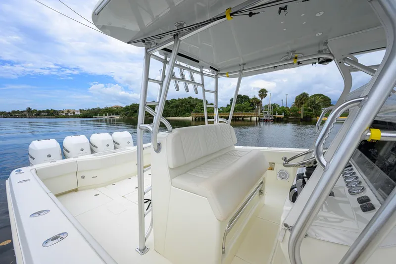 Slide: The Image of 2016 SeaVee 390Z boat interior with seating and multiple outboard engines on a calm waterway. - 51