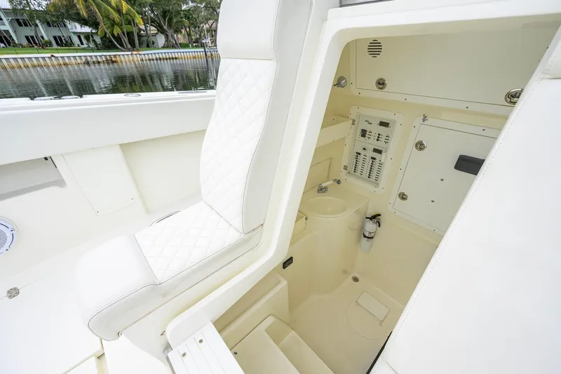 Slide: The Image of 2016 SeaVee 390Z boat interior with white seating and control panel. - 35