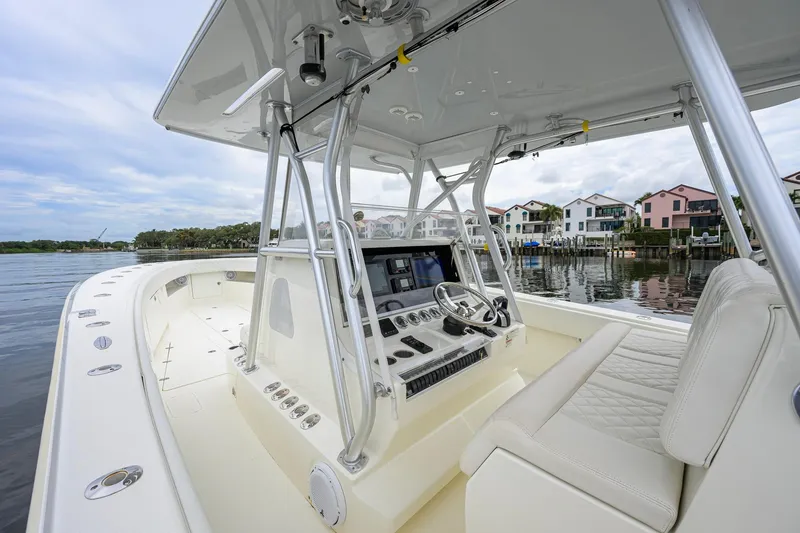 Slide: The Image of 2016 SeaVee 390Z boat interior with helm, steering wheel, and waterfront view. - 44