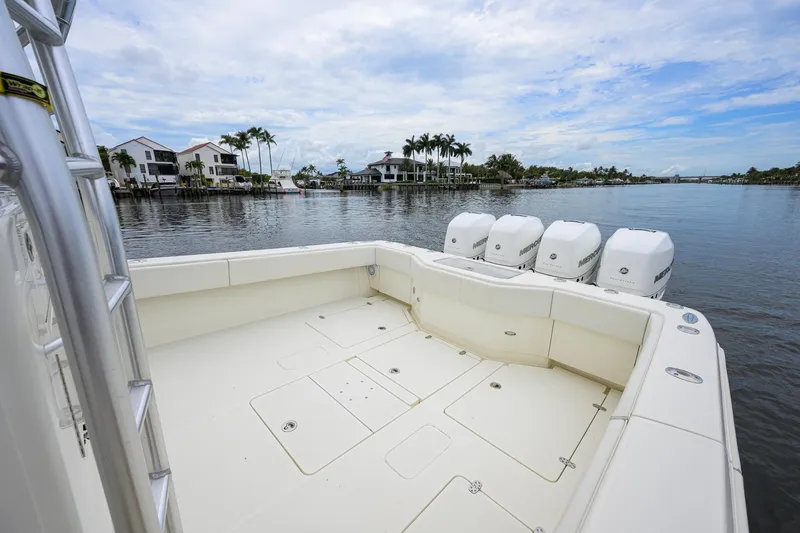 Slide: The Image of 2016 SeaVee 390Z boat with four outboard engines on a calm waterfront. - 17