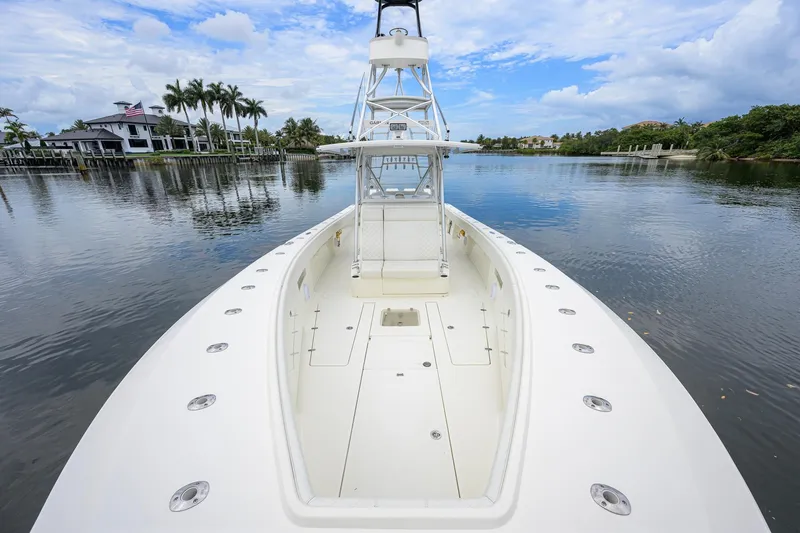 Slide: The Image of 2016 SeaVee 390Z boat on calm water, showcasing spacious deck and sleek design. - 3