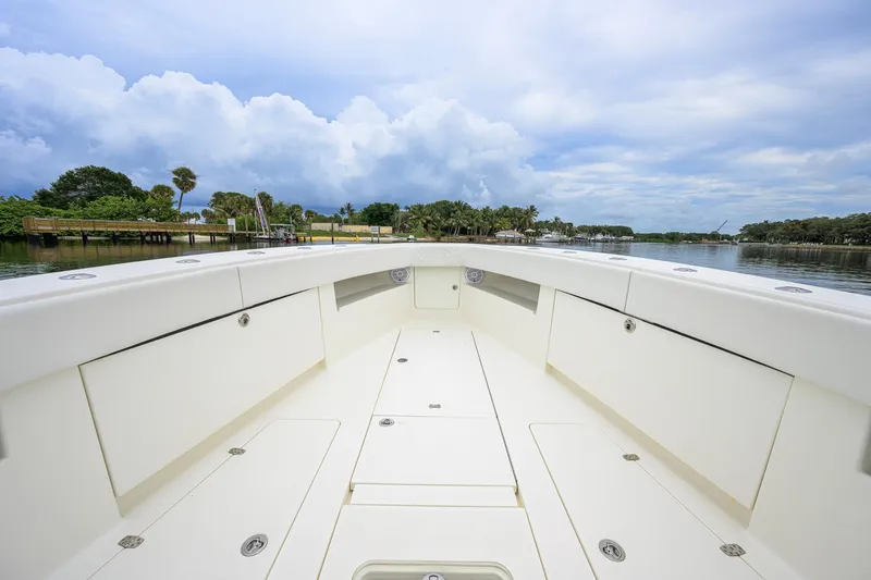Slide: The Image of 2016 SeaVee 390Z boat interior with spacious deck and scenic waterfront view. - 10