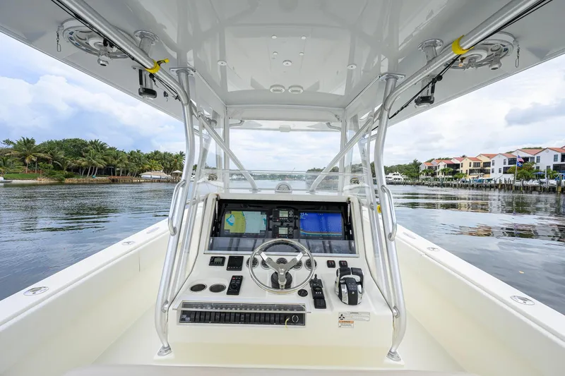 Slide: The Image of 2016 SeaVee 390Z boat helm with advanced navigation system on calm waters. - 46