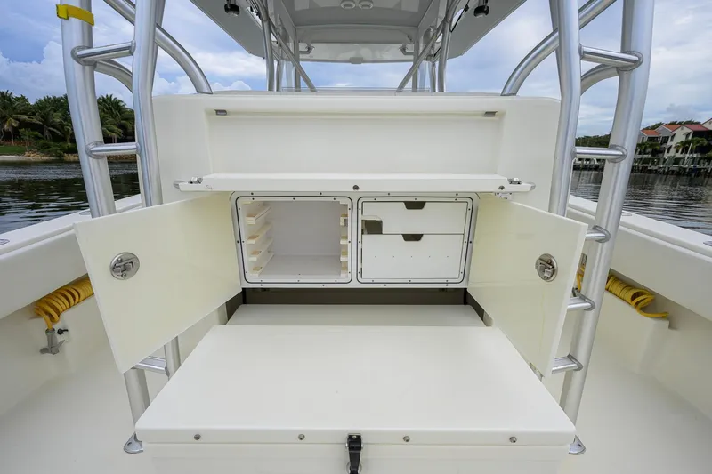 Slide: The Image of 2016 SeaVee 390Z boat storage compartment with open doors, showcasing interior shelving. - 30