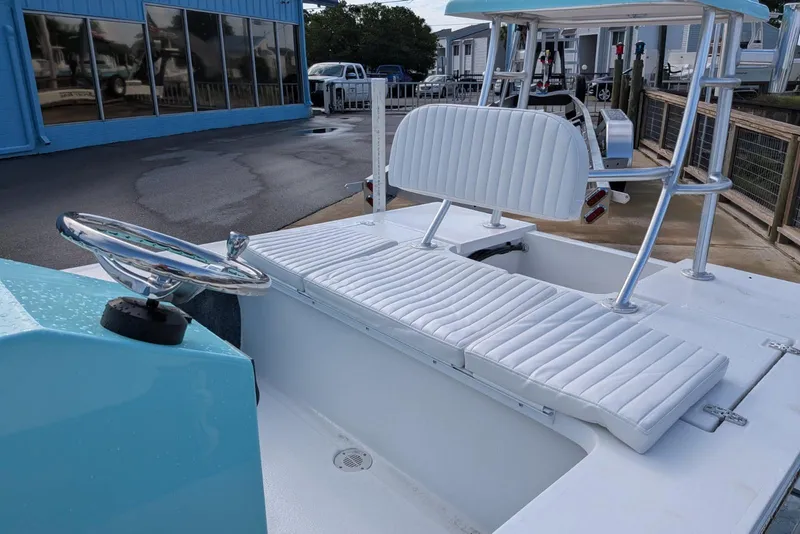 Slide: The Image of 2026 Mitzi Skiffs 17 Tournament boat interior with white seating and steering wheel. - 5