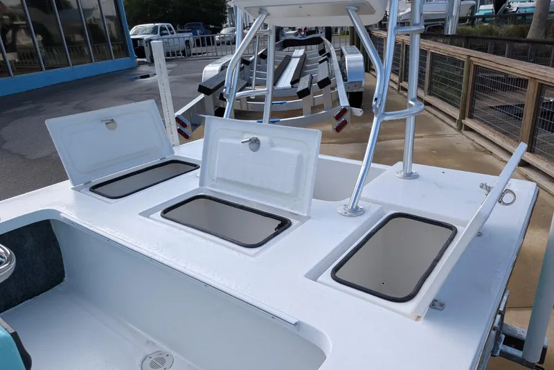 Slide: The Image of 2026 Mitzi Skiffs 17 Tournament boat with open storage compartments and sturdy metal framework. - 6