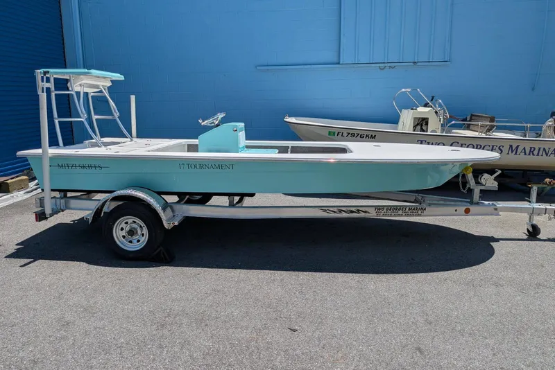 Slide: The Image of 2026 Mitzi Skiffs 17 Tournament boat on trailer, parked outdoors. - 2