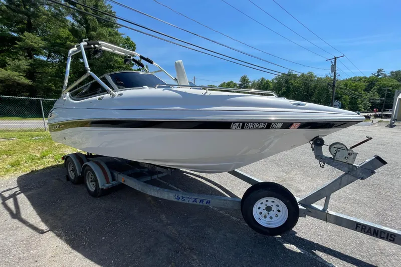 The Image of 2005 Ebbtide 2200 Bow Rider boat on trailer, parked outdoors. - 1