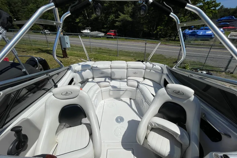 Slide: The Image of 2005 Ebbtide 2200 Bow Rider boat interior with white seating and sleek design. - 4