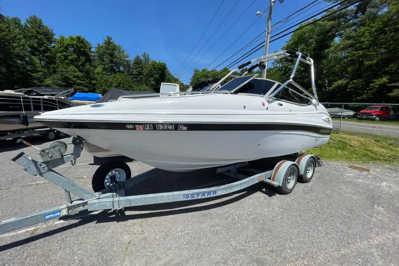 Slide: The Image of 2005 Ebbtide 2200 Bow Rider boat on trailer, parked outdoors. - 2