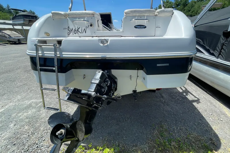 Slide: The Image of 2005 Ebbtide 2200 Bow Rider boat rear view with ladder and outboard motor. - 7