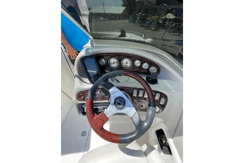 Slide: The Image of 2005 Ebbtide 2200 Bow Rider dashboard with steering wheel and gauges. - 6