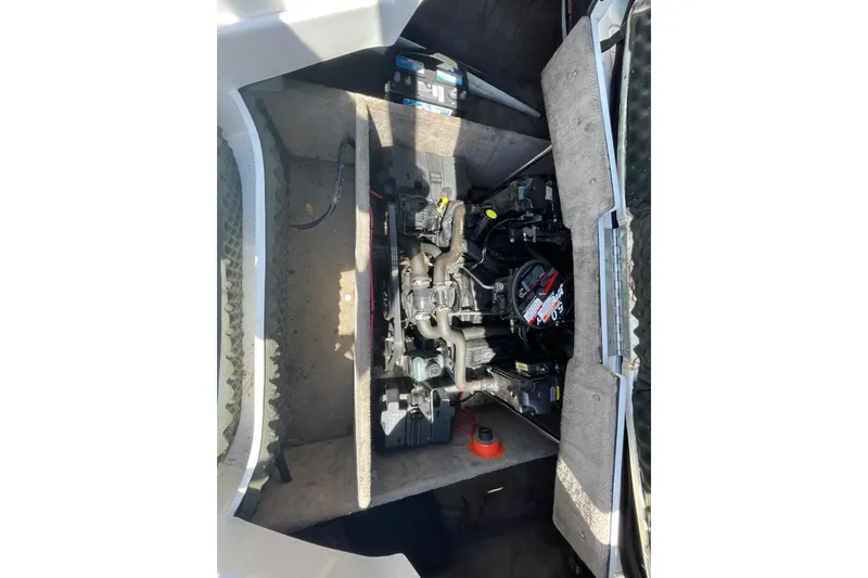 Slide: The Image of Engine compartment of a 2005 Ebbtide 2200 Bow Rider boat, showcasing mechanical components. - 12
