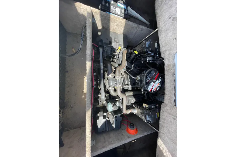 Slide: The Image of Engine compartment of a 2005 Ebbtide 2200 Bow Rider boat, showing detailed components. - 11
