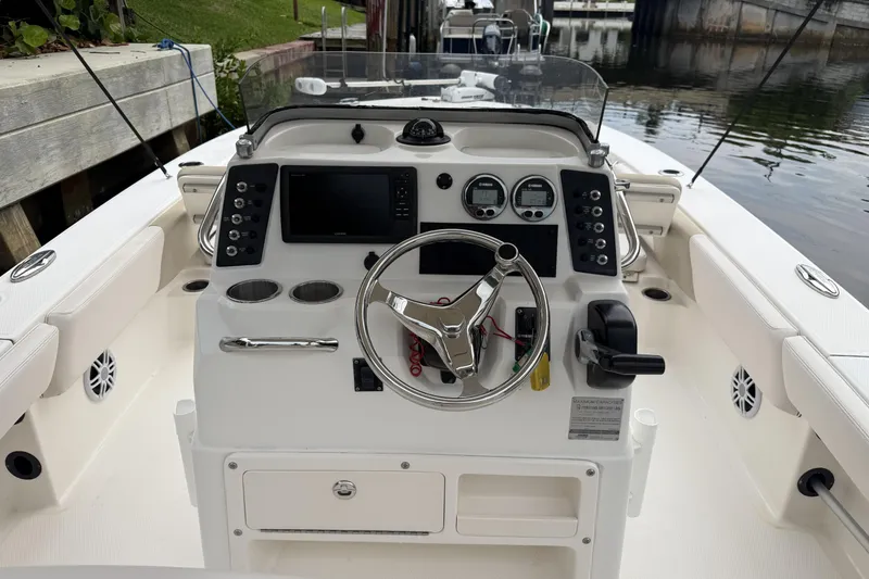 Slide: The Image of 2016 Robalo 246 Cayman boat cockpit with steering wheel and control panel. - 10